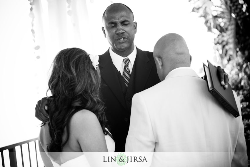 The father conducting a final prayer under the Capri Laguna Inn gazebo prior 